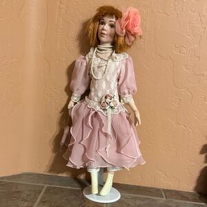 Elegant Pink Porcelain Doll with Floral Accents